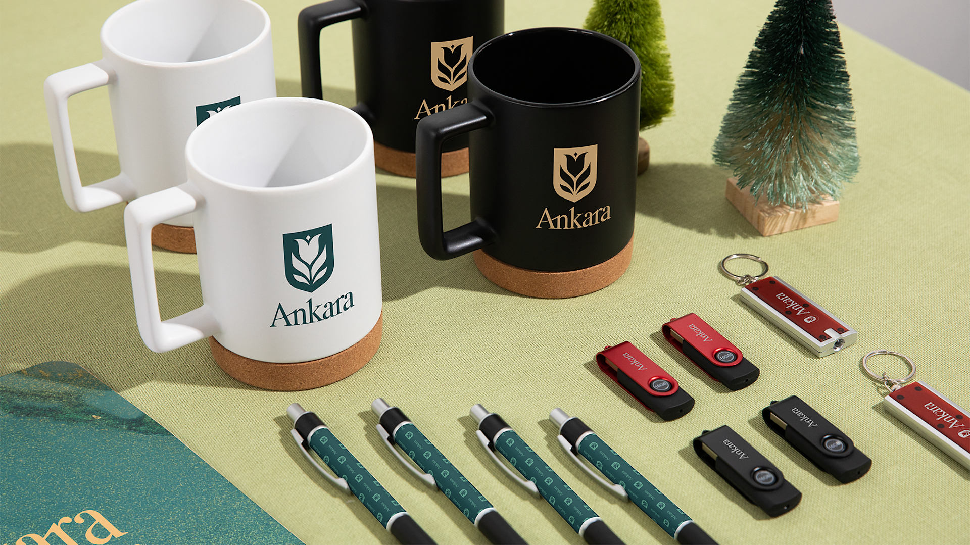 An assortment of custom bottles, pens, hats and keychains promoting a gym business.