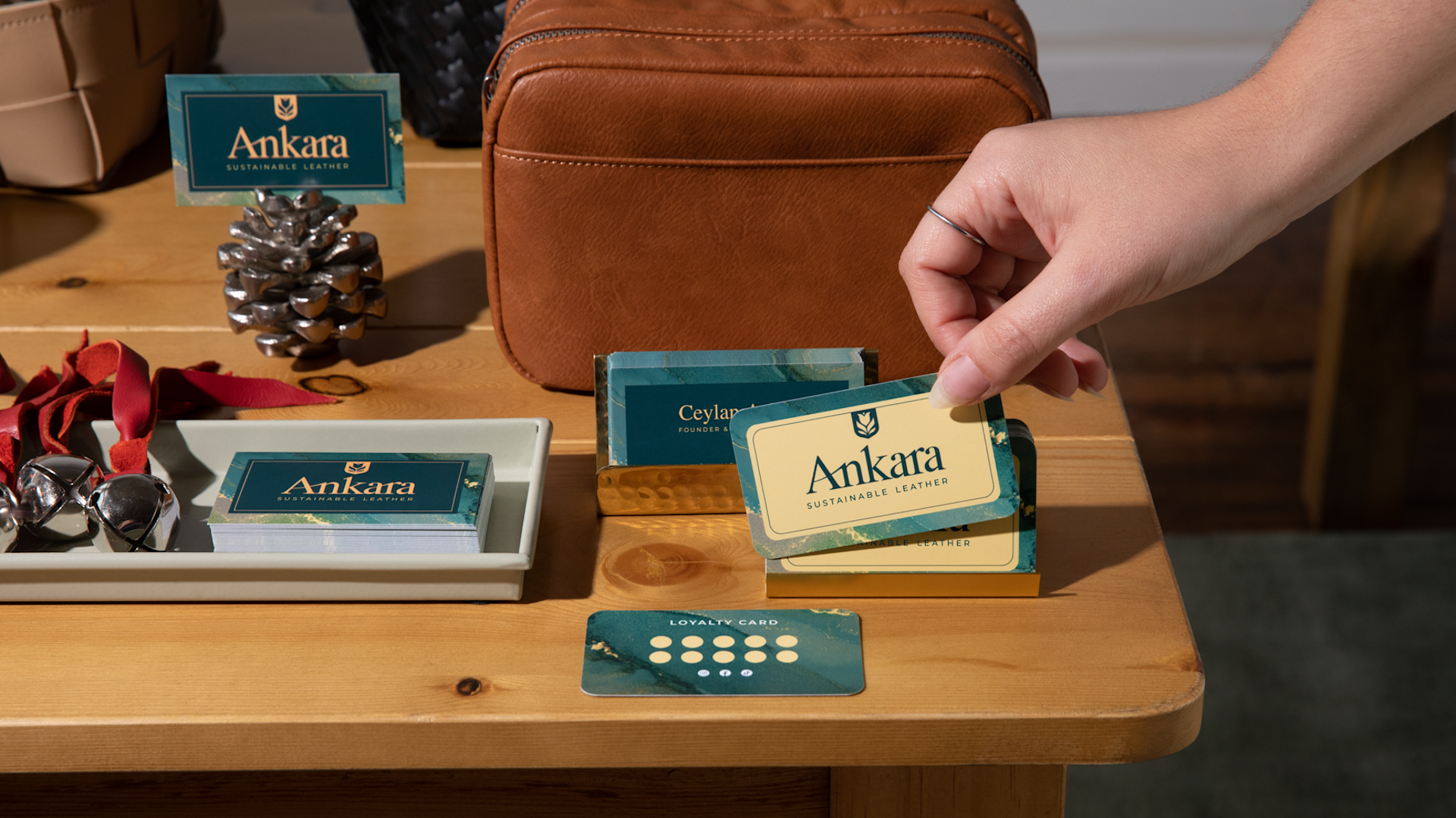 A business owner holding a business card for a crafting business.