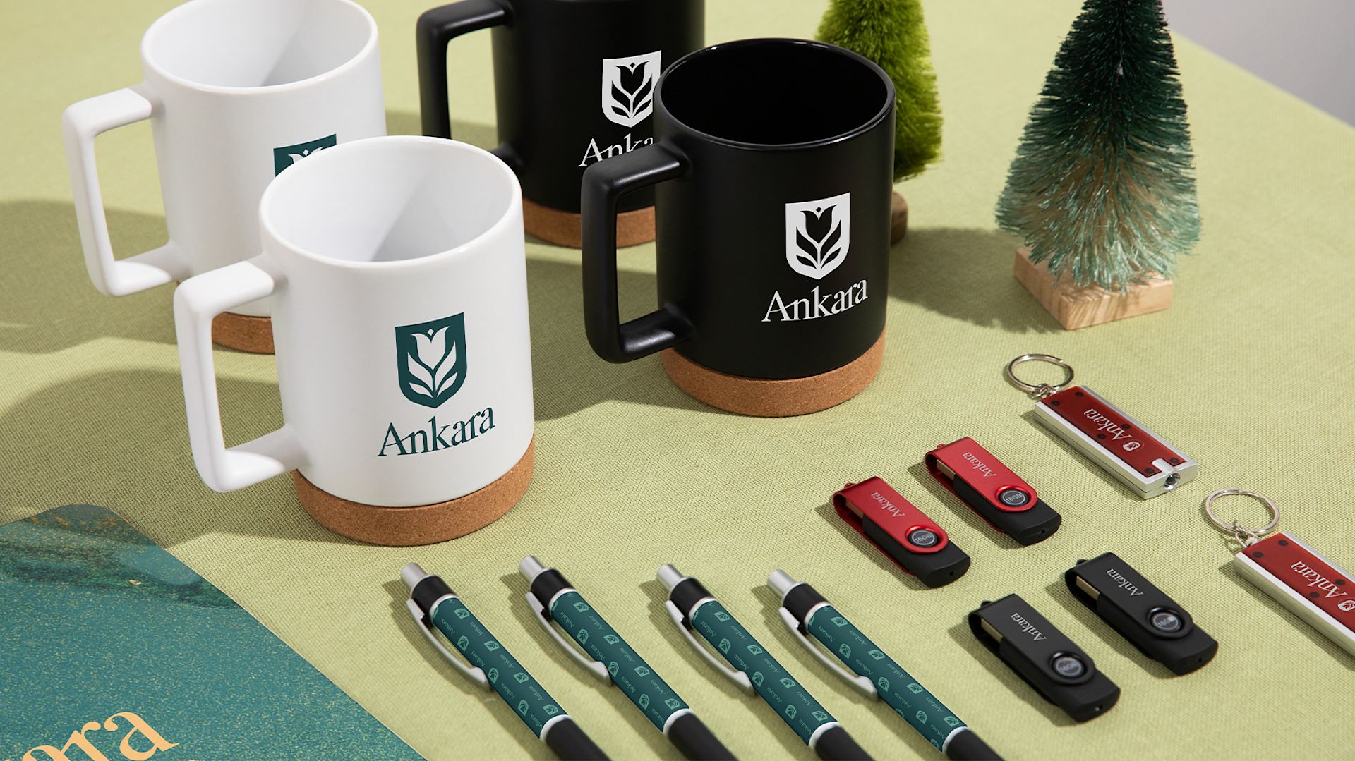 An assortment of custom bottles, pens, hats and keychains promoting a gym business.