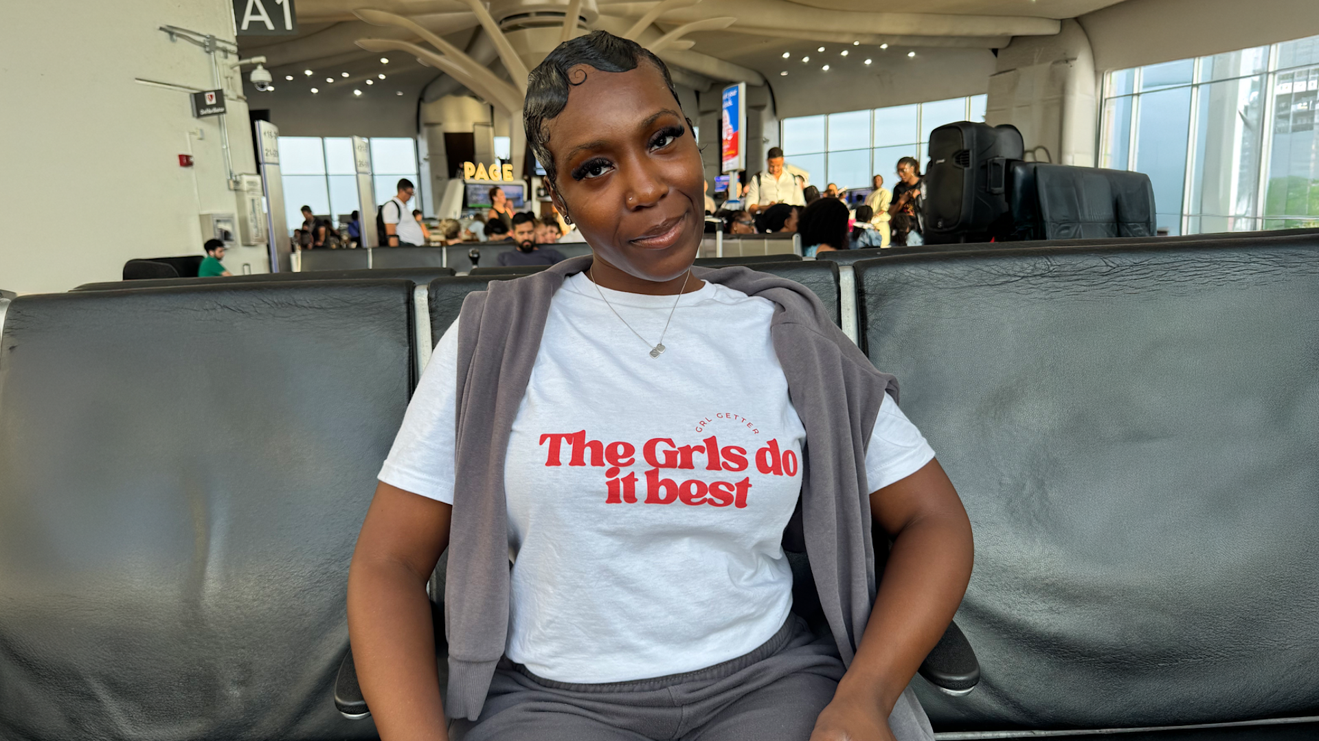 A business owner wearing a custom Gildan T-shirt promoting her brand.