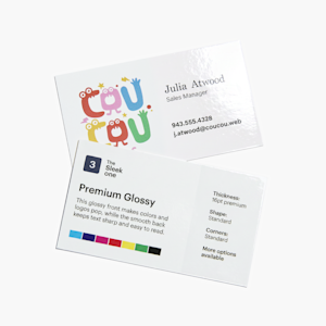 An overhead view of the business card sample kit, with stacks of business cards alongside an open card holder on a white background.