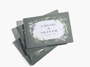 A stack of wedding guest books customized with the couple’s first names.