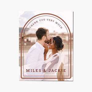 A wedding thank you card with an arch design printing with a wedding photo. 