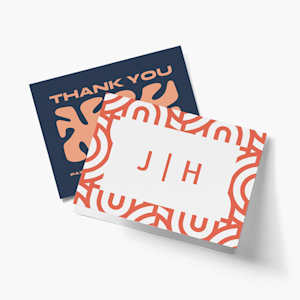 Two custom note cards, one featuring a monogram and another printed with “Thank You”. 