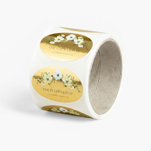 A slightly unravelled roll of circular labels, with a simple black and gold logo.