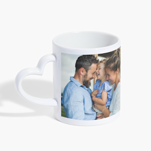 A heart-shaped handle mug featuring a photo of a couple and their young daughter. 