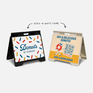 Two small A-frames promoting a donut shop, side by side. One features the business name, while the other has a QR code for the menu.