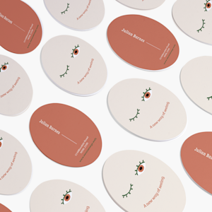 Oval business cards promoting an optometry business, side by side.