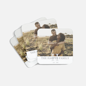 A stack of photo coasters featuring a couple and their family name.