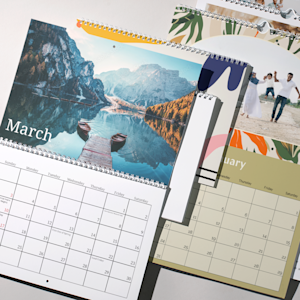 A group of wall calendars printed with different custom designs.