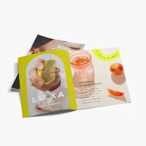 A bi-fold brochure for a health supplements brand laid open on a white surface.
