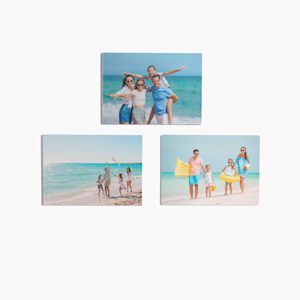 A trio of picture tiles featuring photos of a family at the beach. .