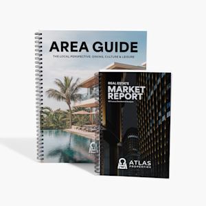 Two wired booklets, one for a travel agency and one for a real estate agency, standing up against a white background.