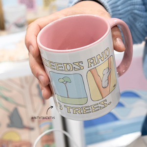 Two white and lilac mugs side by side, featuring a person’s monogram.