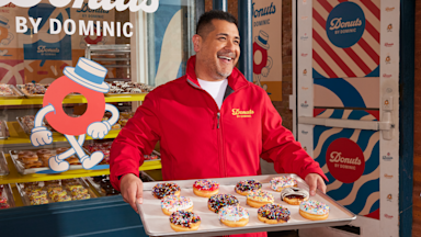 A person wearing a custom softshell jacket while smiling.