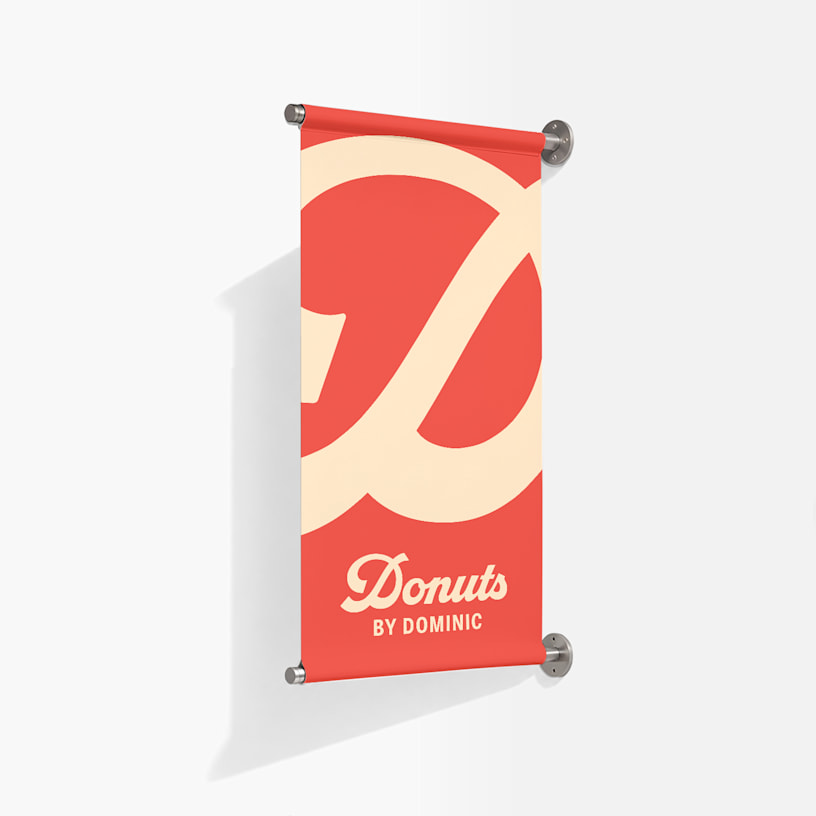 Een aan de muur bevestigd spandoek ter promotie van een donutbedrijf.