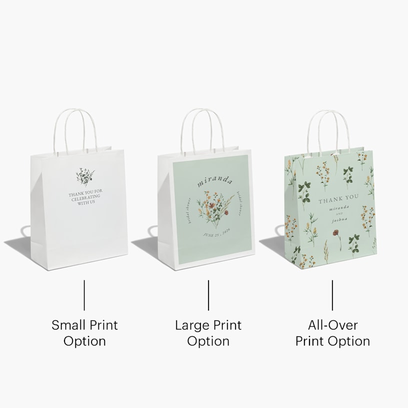 3 party bags from a wedding celebration featuring floral patterning and filled with salmon tissue paper.