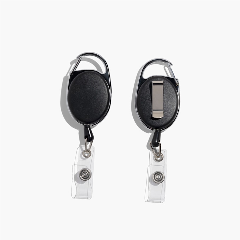2 black oval-shaped badge holders with a retractable reel and belt clip attachment, displayed from front and back, and featuring clear plastic snap-straps.