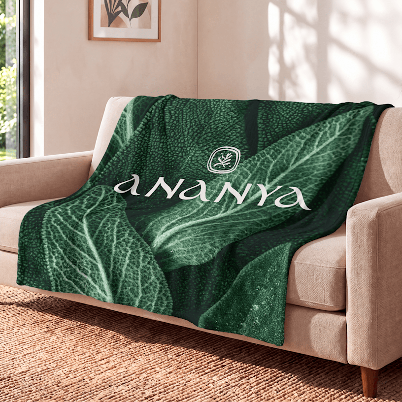 A blanket customized for a spa draped over a waiting room couch. 