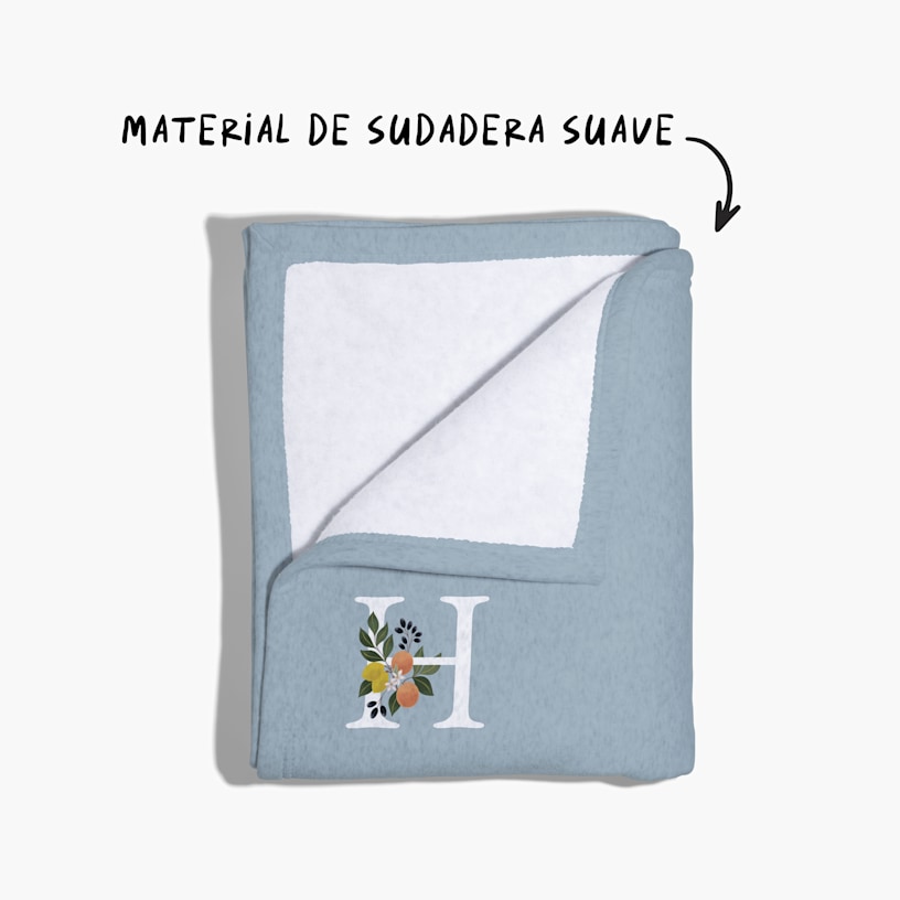 Una manta sudadera con un pliegue en la esquina, con una nota que dice "material de sudadera suave". 
