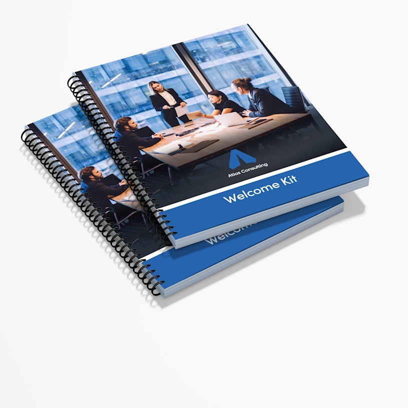 A stack of wire-bound reports and consulting materials for business services.