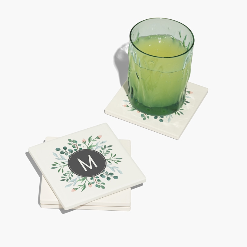A square ceramic coaster set customized with the monogram M. 