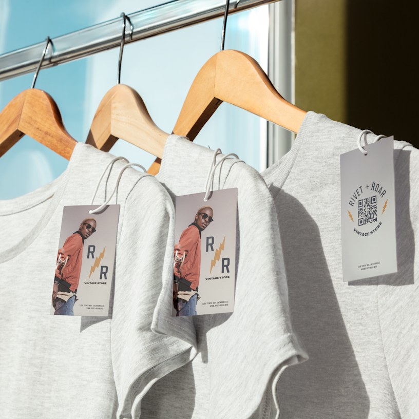 3 hang tags tied onto t-shirts with string.