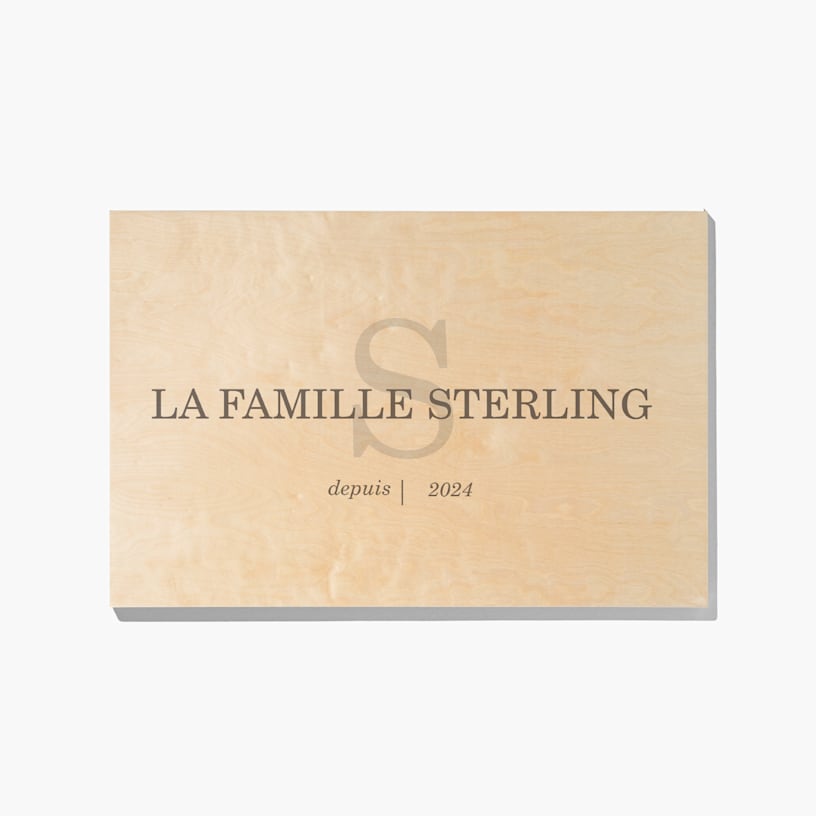 A wood print customized with a monogram, family name, and year. 