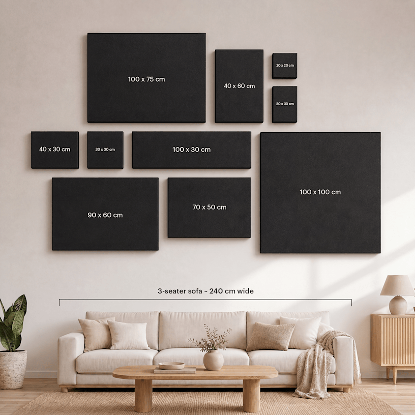 Assorted custom photo canvases hanging on a wall, labelled by their sizes.