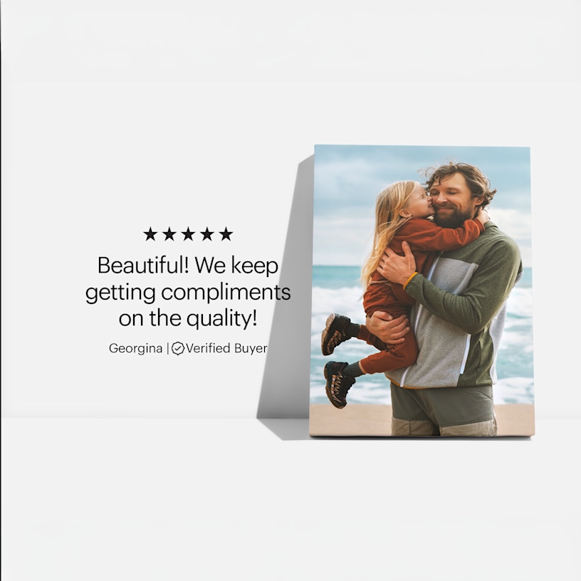 A canvas print featuring a photo of a father and his daughter at the beach, and a customer review: “Beautiful! We keep getting compliments on the quality!”