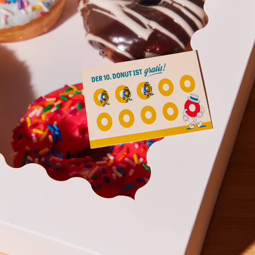Bonuskarte eines Donutladens mit Stempelabdrücken, die für die Anzahl an Käufen stehen.