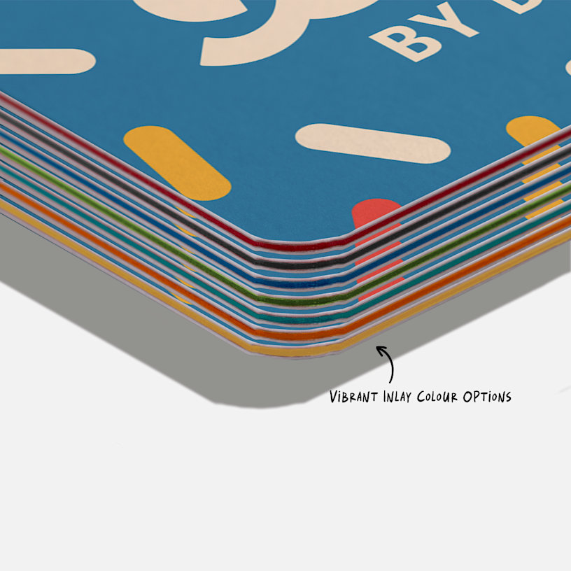 A stack of custom triple layer business cards with three different inlay colours: blue, citrine and bright red.