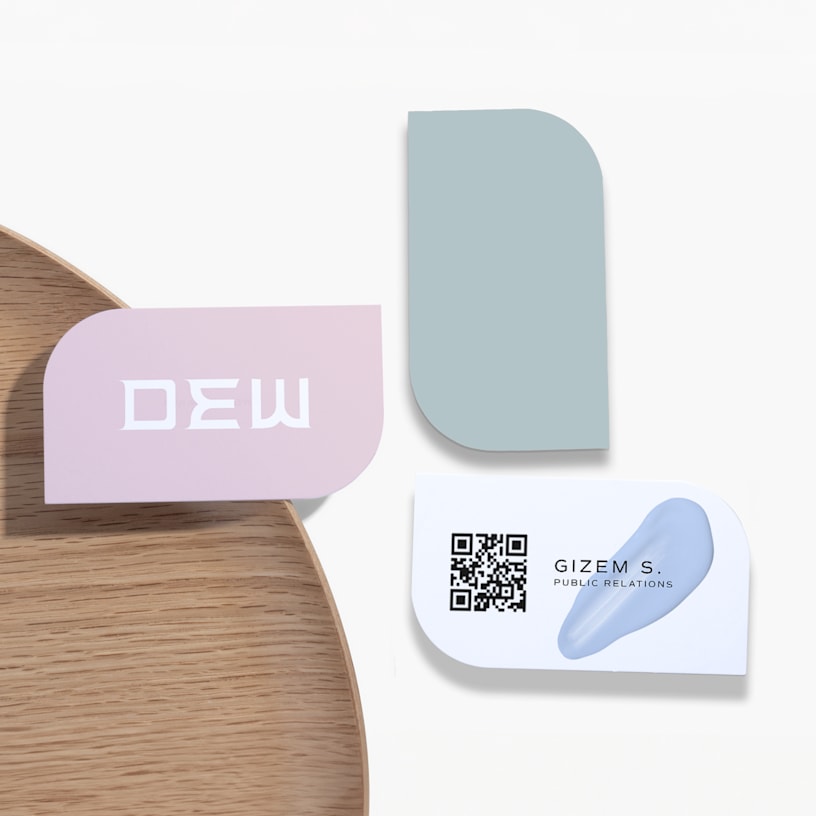 Leaf shaped business cards promoting a cosmetics business, with a QR code on the back.