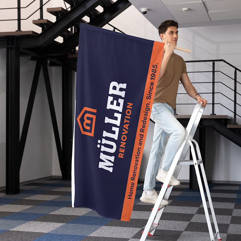 A wall flag promoting a wellness brand, being installed by a man.
