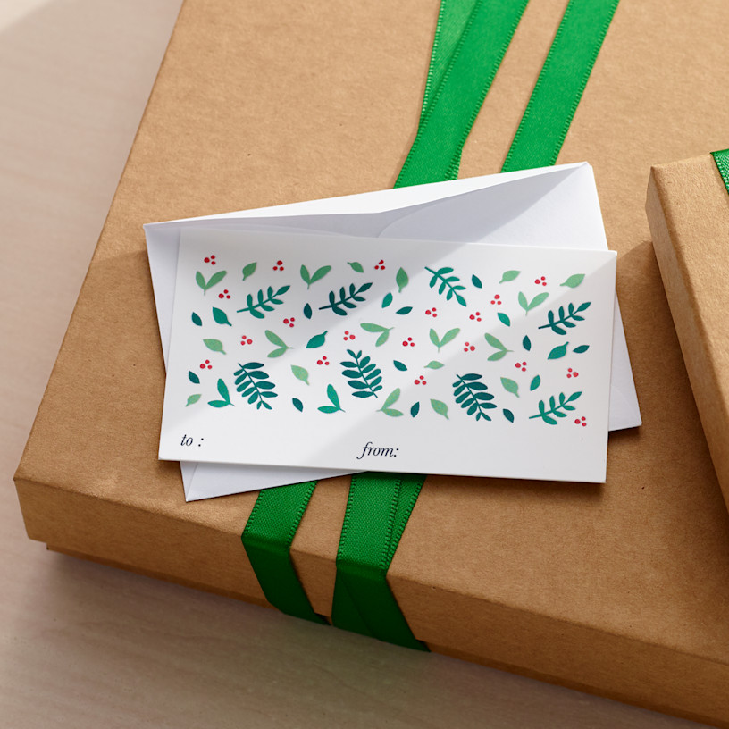 A custom gift tag featuring a holiday design with a blank white envelope. 