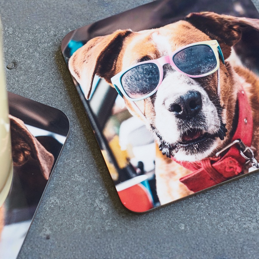 A stack of personalized drink coasters featuring a dog wearing sunglasses. 