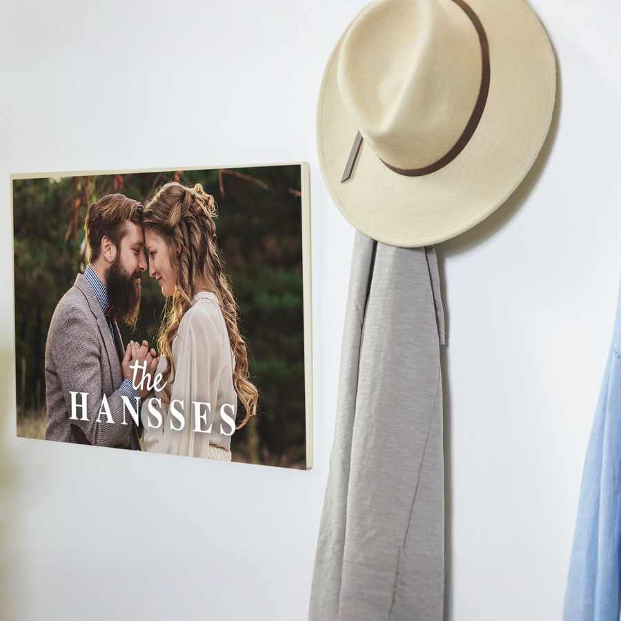 A photo wood print displayed on a wall printed with a couple’s wedding picture.