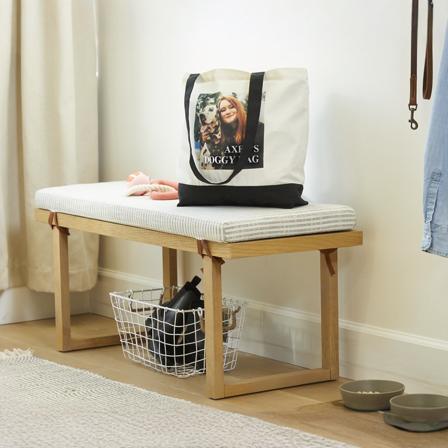 A custom cotton tote bag printed with a photo of a woman and her dog. 
