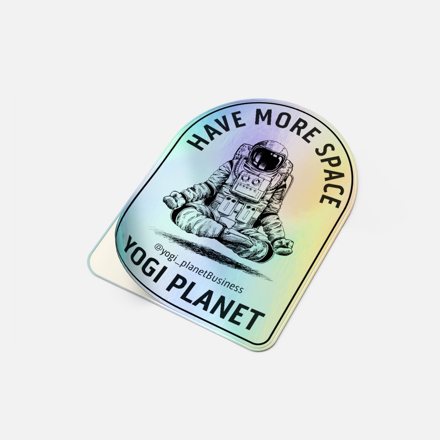 A holographic sticker from a yoga company featuring an astronaut and a caption that reads “have more space”.