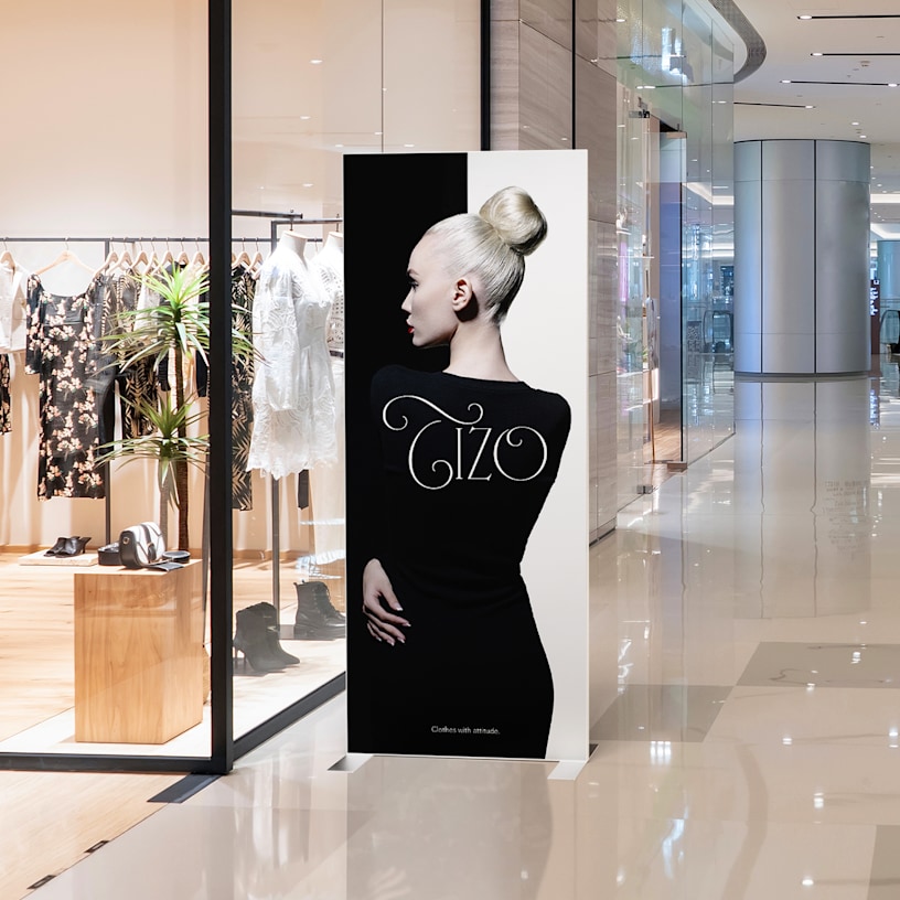 A SEG fabric stand shown outside of a boutique.