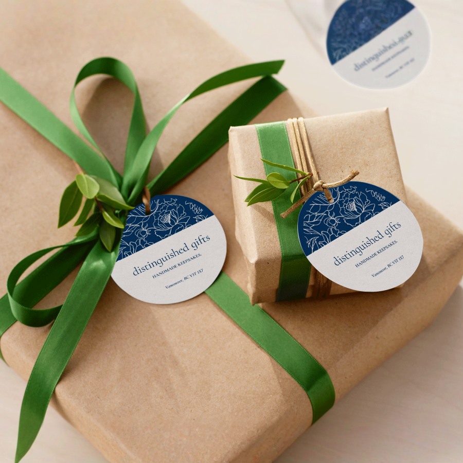 2 hang tags tied onto wrapped gifts with string.