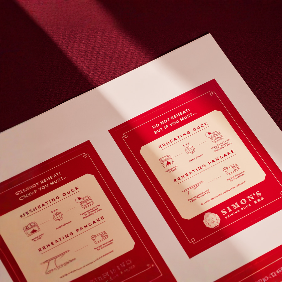 A sheet of labels from an Asian cuisine restaurant featuring instructions on how to best reheat their duck and pancakes.
