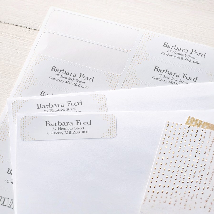 Some letters with return address labels placed in the corners, alongside the sheet the labels had been peeled from.