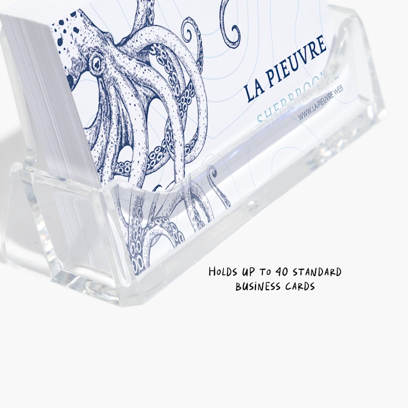 An acrylic business card holder holding business cards for a restaurant, with a note that they can hold up to 40 standard business cards. 