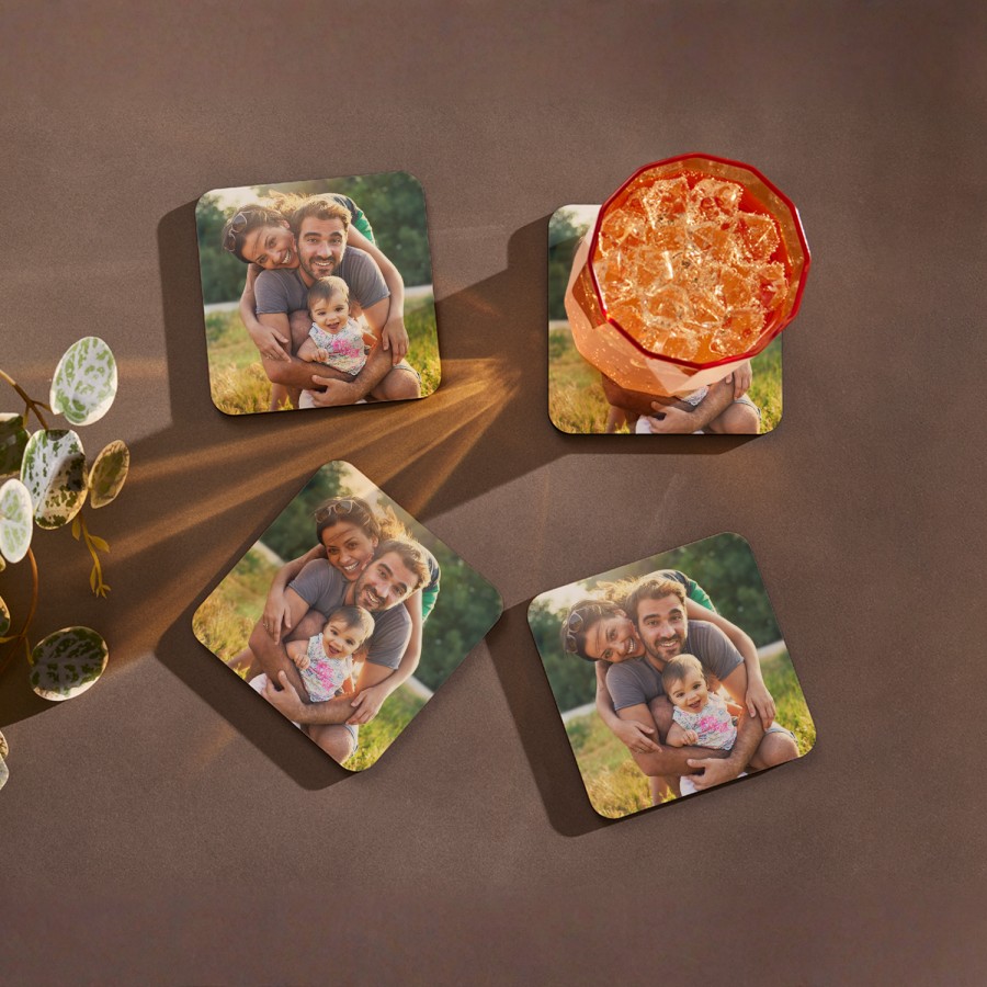 Photo coasters featuring a couple and their baby. 