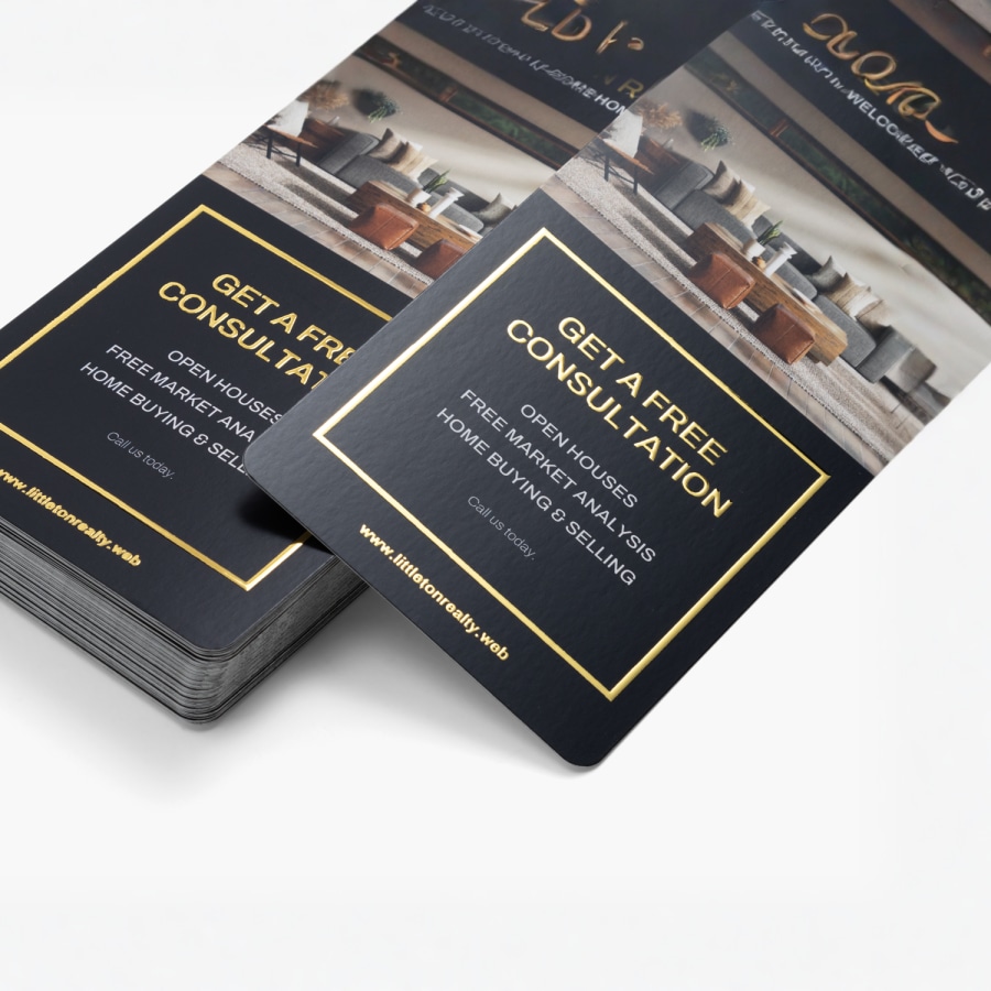 A stack of gold embossed foil rack cards advertising a free consultation for a real estate company. 