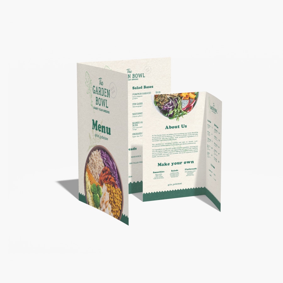 Small and large bi-fold menus for a health foods restaurant, propped up beside each other.