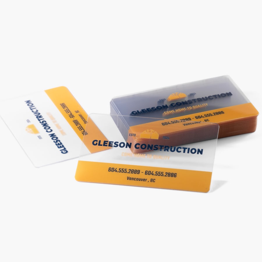 A stack of clear plastic business cards for a construction business.