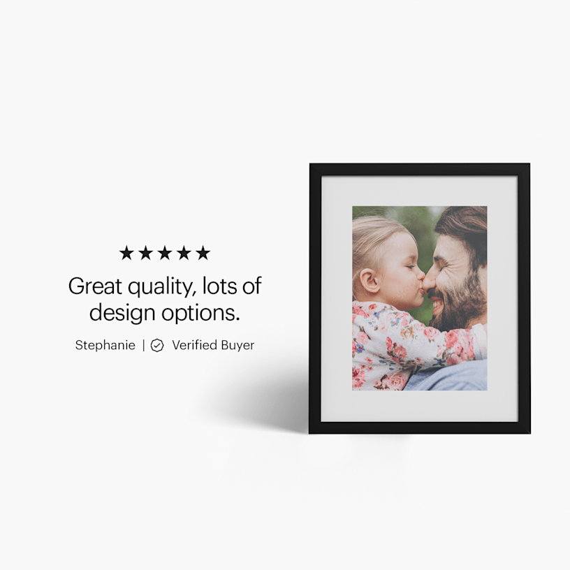 A framed print featuring a photo of a child and man hugging. 