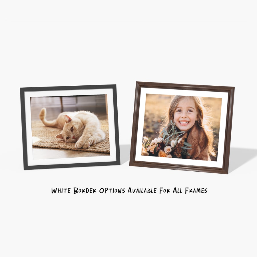 Two framed prints featuring a cat and a little girl, with a note that says white border options are available for all frames. 